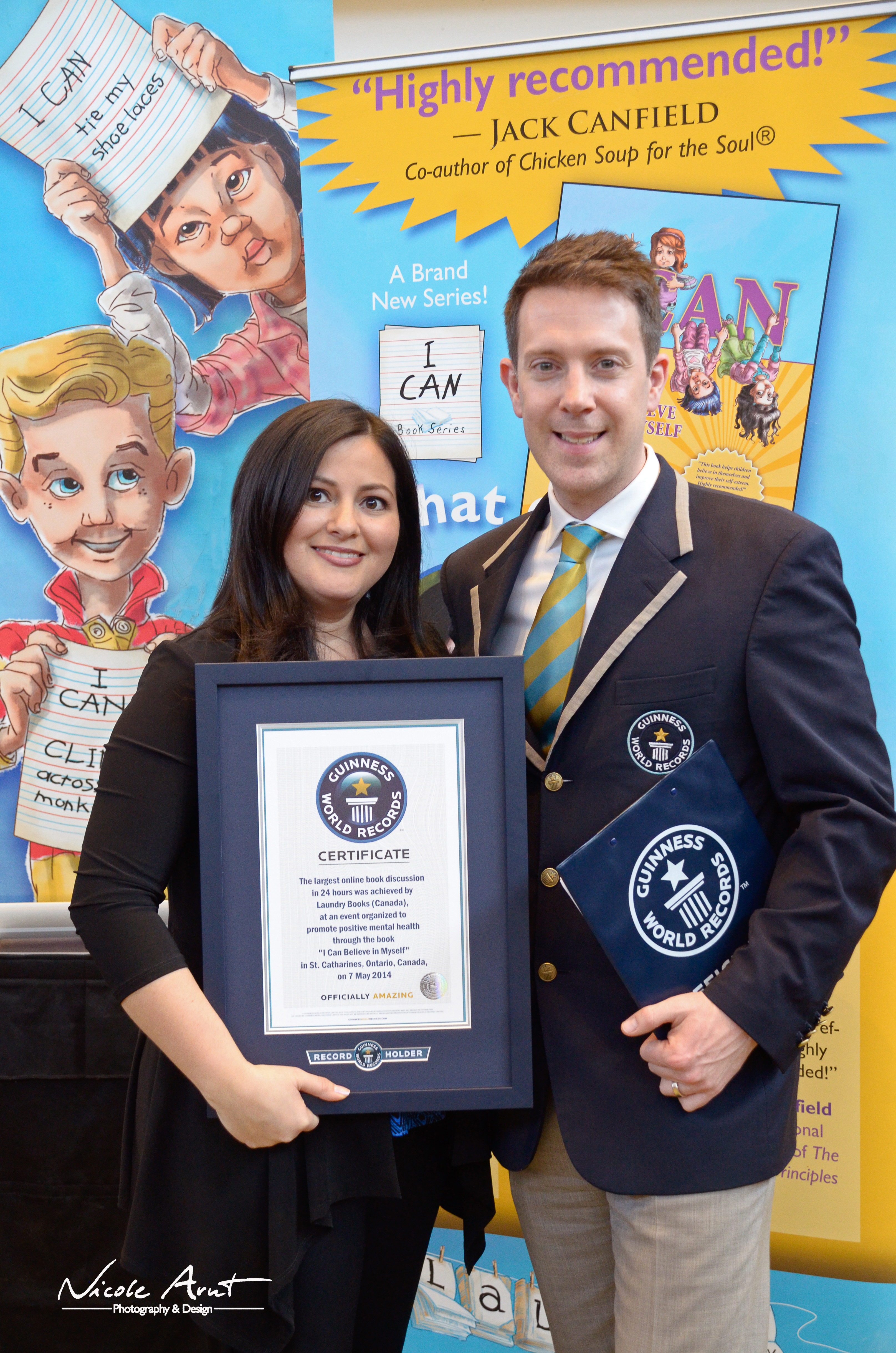 Miriam achieving her biggest goal, holding her Guinness World Record next to the Guinness World Record adjudicator.