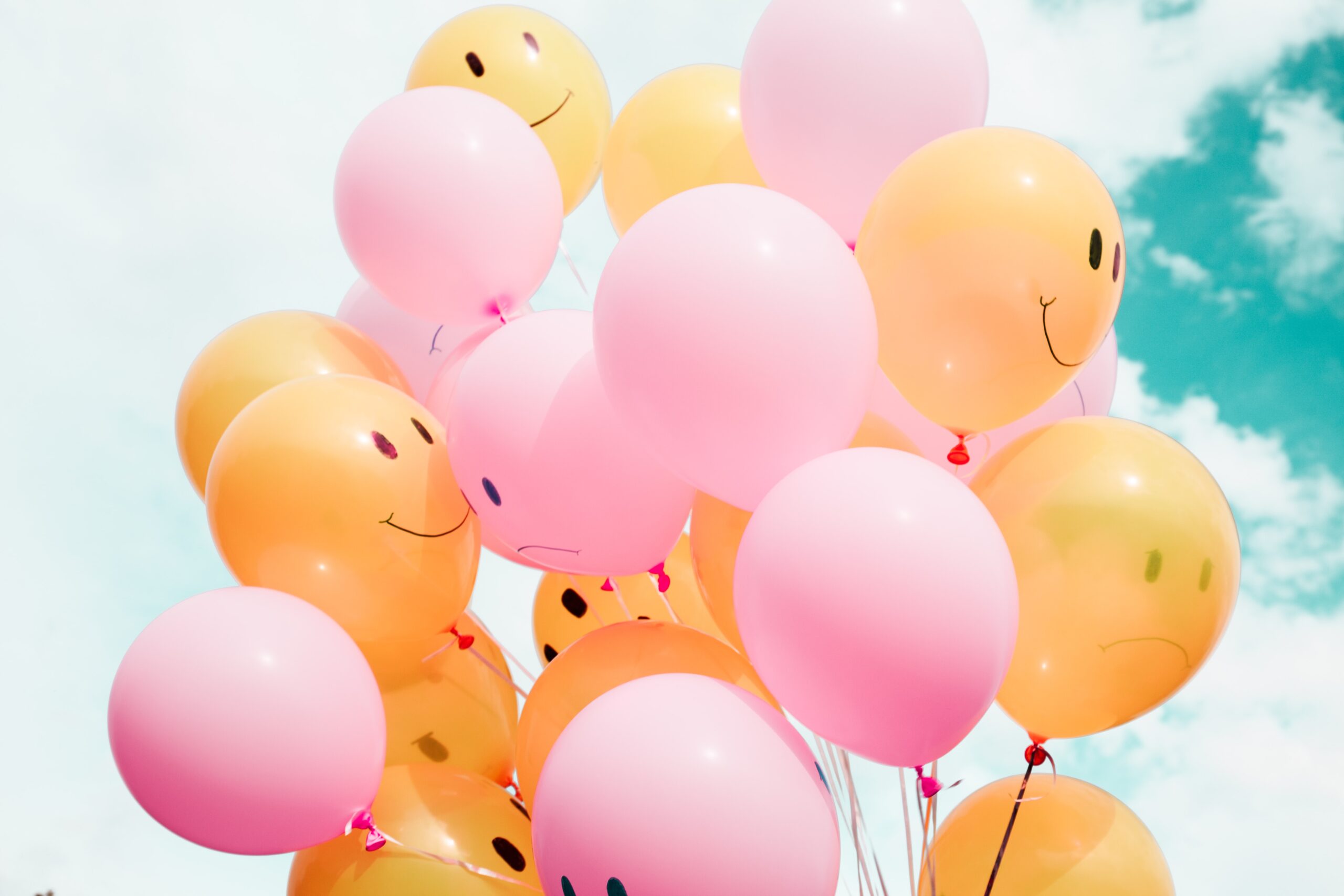 Balloons with smiling and frowning faces on them.